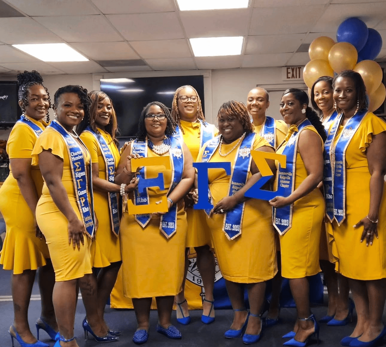 Xi Gamma Sigma charter members holding Greek letters